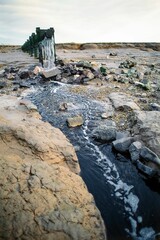 Effluent pipe discharging wastewater from nearby industry into the Severn Estuary