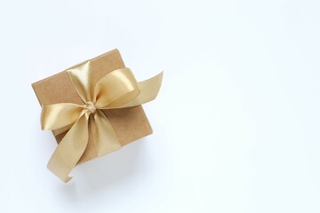 Beautiful gift box tied with bow on white background 