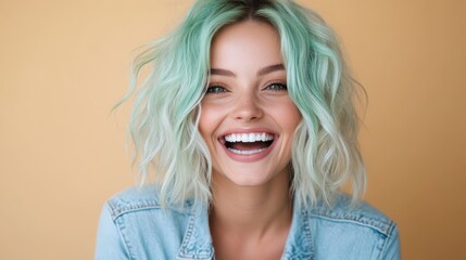 A woman smiling warmly, her green hair contrasting beautifully with a denim jacket, set against a...