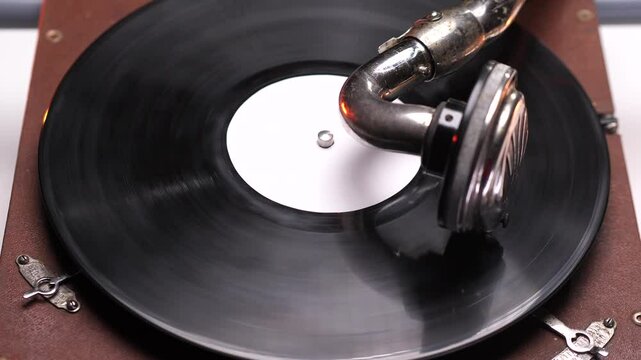 Vintage gramophone playing a vinyl record with white label