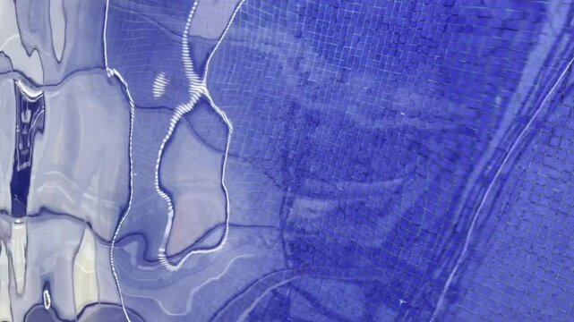 Vertical video of blue transparent water surface with waves in swimming pool