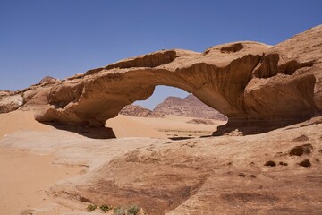 Jebel Kharaz rock bridge in Wadi Rum desert in Jordan. Beautiful travel destination of Arabia in Valley of the Moon.