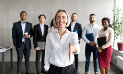Cheerful Businesswoman Stretching Hand For Handshake Greeting To Camera Making Career Offer...