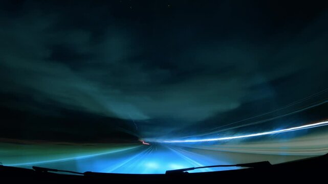Capturing the motion of a nighttime drive under cloudy skies with dazzling light trails