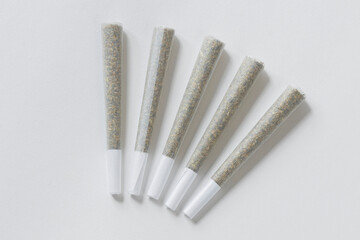 Clean overhead photo of Four Marijuana Joints on white background