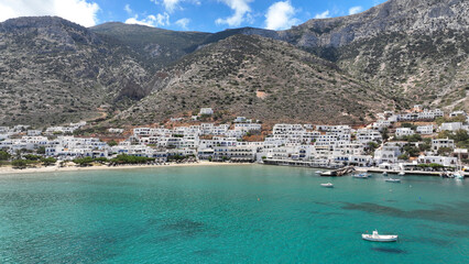 Obraz premium Aerial drone photo of famous port and small picturesque seaside village of Kamares, Sifnos island, Cyclades, Greece