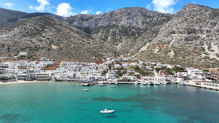 Obraz premium Aerial drone photo of famous port and small picturesque seaside village of Kamares, Sifnos island, Cyclades, Greece