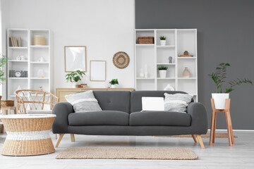 Interior of living room with modern sofa, coffee table and shelving units