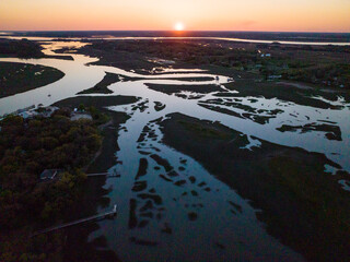 Aerial drone views of snake-like rivers and marshes in lowcountry tidal areas of Southern Carolina
