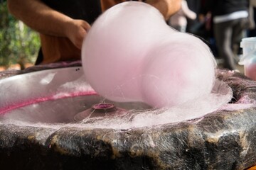 Street Vendor Making Fresh Cotton Candy at a Market