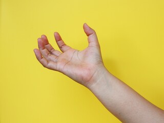 Naklejka premium Hands holding something on yellow background with clipping path.