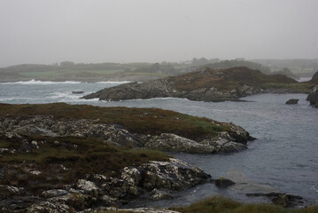Waves crashing on rocks on a rainy morning. Wild Atlantic Way, Irland.