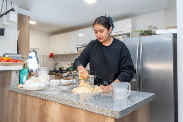 A woman is making food in a kitchen