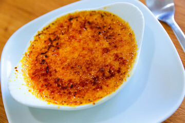 Portion of delicious burnt cream in white bowl