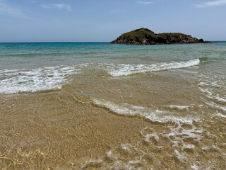 Clear Waters of Sardinian Beach with Small Island in the Background