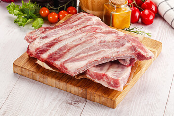 Raw pork ribs over board