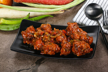 Manchurian chicken with sauce and spices