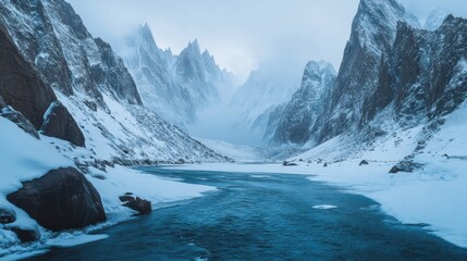 Fototapeta premium Majestic Snow-Covered Mountains and Serene River in a Remote Winter Landscape with Fog and Ice, Capturing the Beauty of Nature and Tranquility in a Scenic View