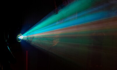 Colorful projector light beam in dark room