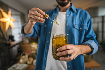 close up of man herbalist prepare natural oils in a rustic workshop
