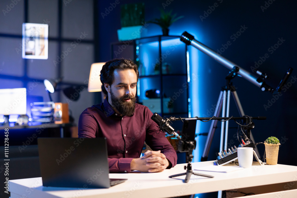 Poster online star talking in front on smartphone attached to tripod and high quality mic in studio, discus