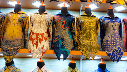 Colorful batik cloth on display in a shop. Perfect for fashion blogs or promoting Indonesian culture.