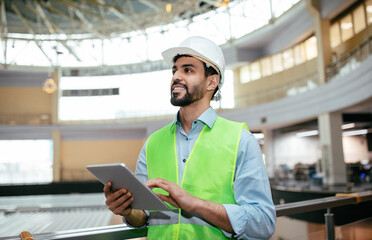 Smiling handsome young muslim male engineer with beard in hard hat and protective uniform with...