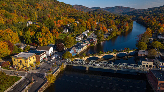 10/12/22 SHEFFIELD FALLS, MA., USA - aerial view at sunrise of Sheffield Falls in autumn, Ma. with Housatonic River running through town, Berkshire Mountains