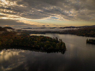 10/10/22 Indian Lake, NY, USA - aerial view above clouds of Blue Mountain Lake at sunrise in Adirondack, NY State