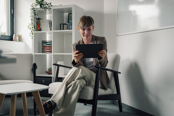 Businesswoman using digital tablet in modern office