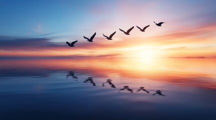 Fototapeta premium Flock of birds flying over calm ocean at dawn, sky blending with soft colors, freedom and serenity