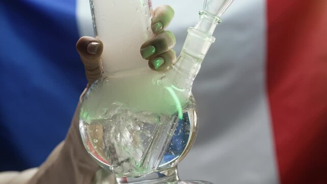 Woman Smoking Medical Marijuana, Glass Water Bong On French Flag Background