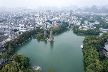 Aerial View of Serene Lake Surrounded by Urban Landscape and Mountains