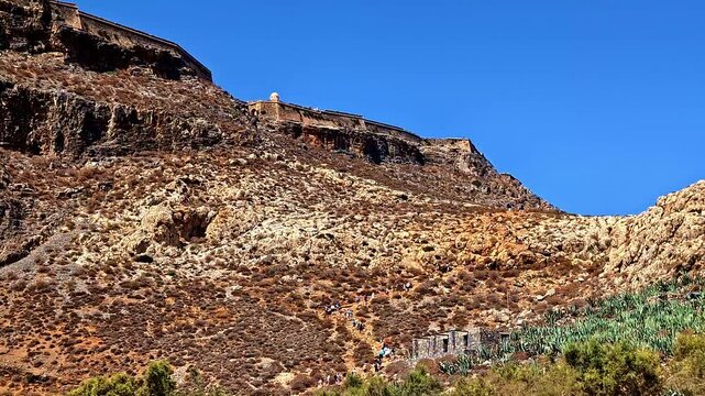 People Climbing To The Mountains Towards The Gramvousa Fortress In Gramvousa Beach, Minoa Pediada, Greece. Low Angle Shot