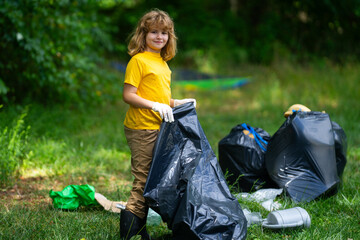 Child collecting trash outside. Ecology concept. Environmental pollution. Earth Day. Recycle waste...
