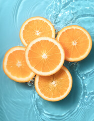orange slices floating in a clear blue water