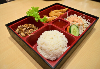 This bento is made with premium chicken and fresh leafy vegetable. Left view.