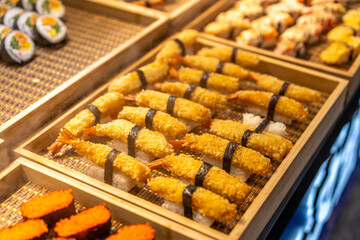 Exquisite Japanese Sushi Display Featuring Crispy Shrimp and Colorful Rolls
