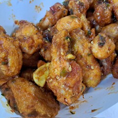 A box of Korean fried chicken with special Korean seasoning. Some pieces come with spicy sauce. Crispy and delicious.
