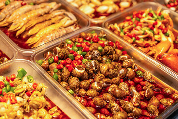 A Colorful Array of Spicy Seafood Dishes in Vibrant Sauces