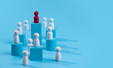 Red wooden figure standing on wooden podium for business leadership for team leader concept.