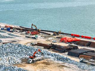 Construction progress on shipping port terminal through land reclamation. Global trade development,...