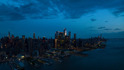 MAY 1, 2023, NEW YORK, NY, USA - sunset dusk view over Hudson River from Weehawken, NJ of New York City midtown