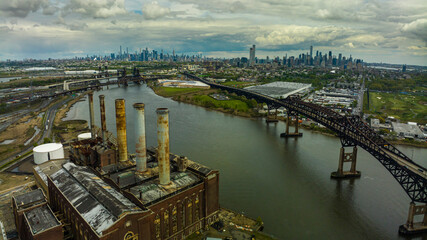 MAY 2, 2023, KEARNY, New Jersey, USA - aerial view of industrial New Jersey with Manhattan New York in background with clouds