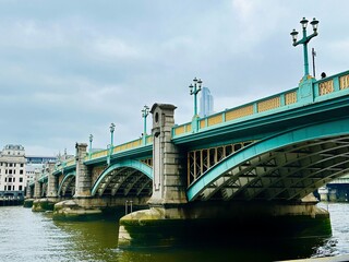 Southwark Bridge, a steel arch bridge that connects the district of Southwark and the City of London across the River Thames.