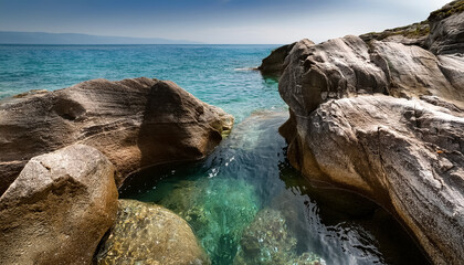Clear water flowing through the gaps in the rocks