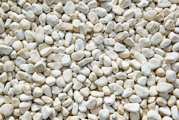 many white beautiful smooth pebbles lie together. High quality photo
