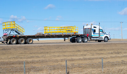 Heavy Cargo on th eroad. A truck hauling freight along a highway. Taken in Alberta, Canada