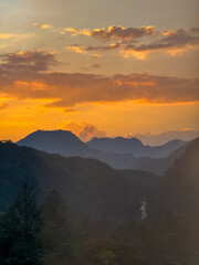 Golden Sunset Over Tropical Mountains and a Serene River Valley