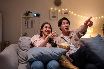 Asian young beautiful woman watching romantic movie on television at home.